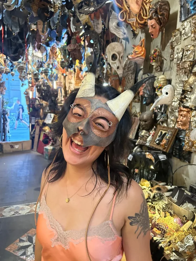 Visitor wearing a handmade mask in the Alice Masks atelier, Florence