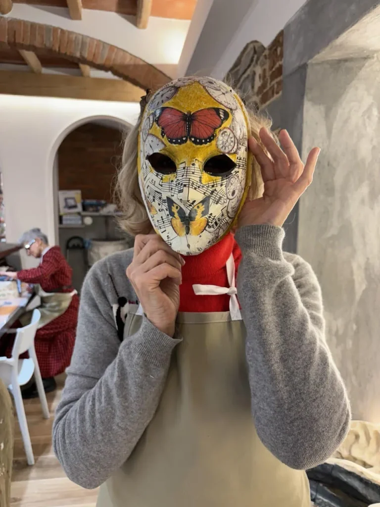 Visitor wearing a handmade mask in the Alice Masks atelier, Florence