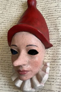 Pinocchio face mask with red hat and ruff collar Pinocchio face mask with red hat and ruff collar, handmade papier-mâché by Alice Masks, Florence