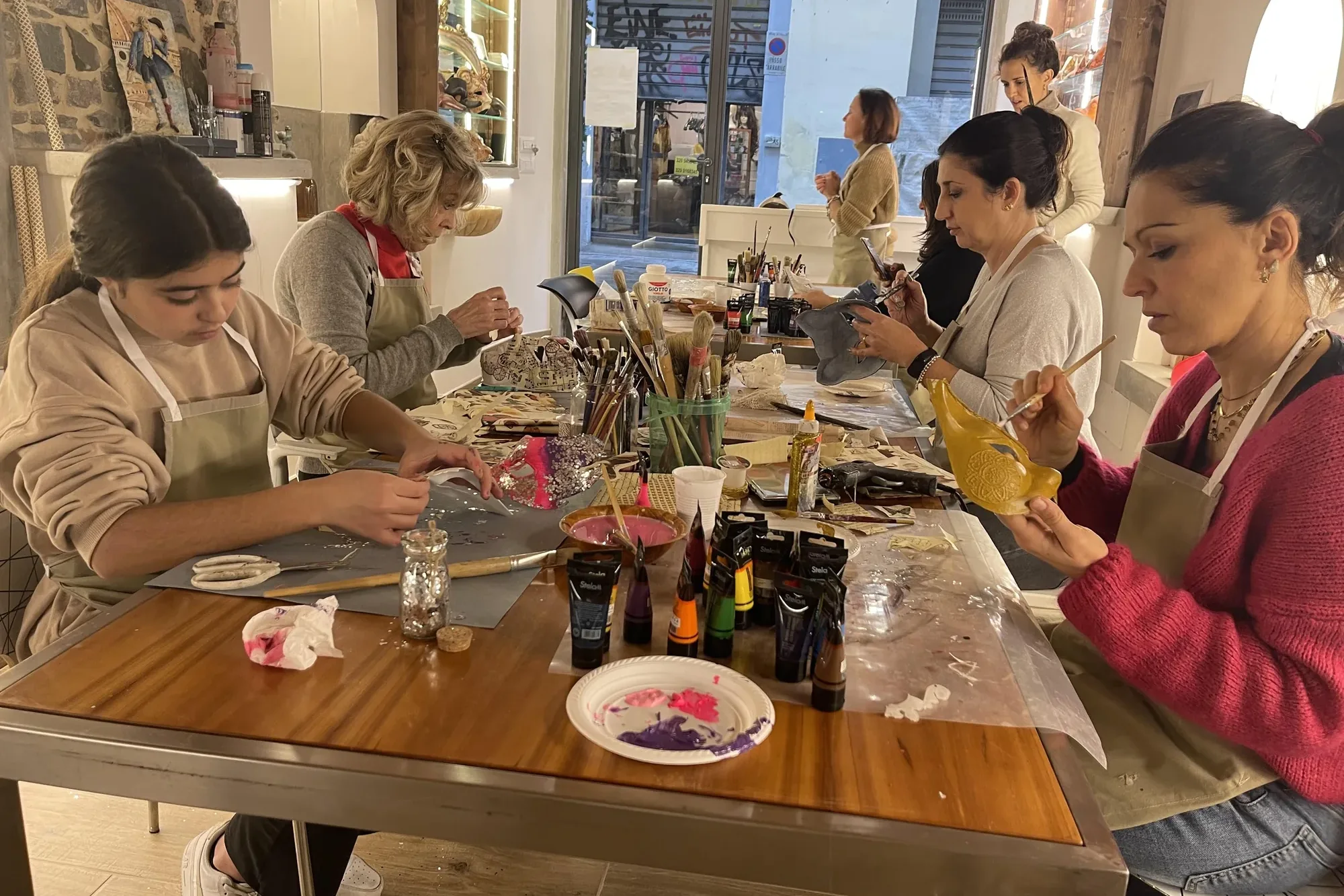 Students decorating masks during the mask decoration course